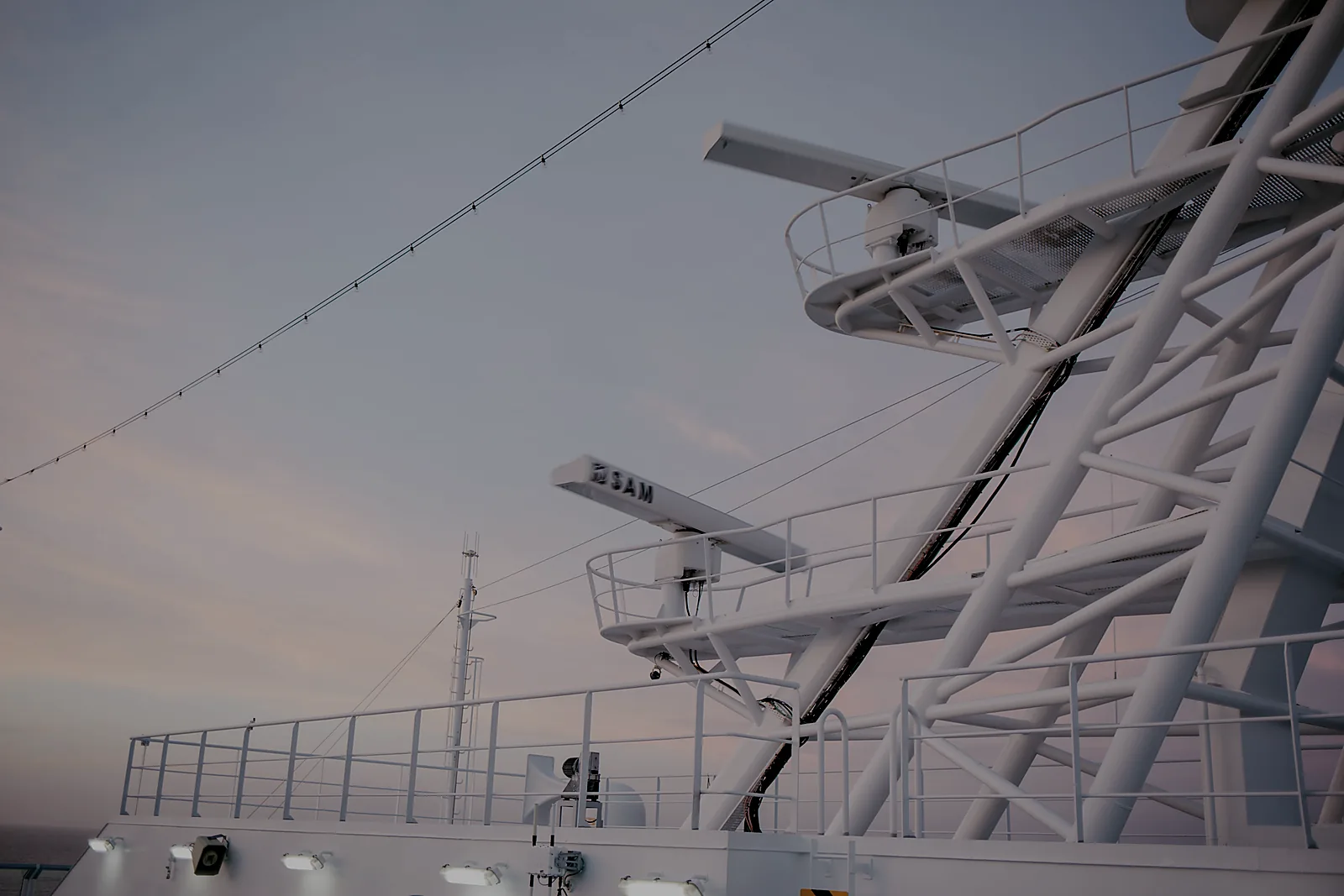 Marine radar and communications mast at dusk
